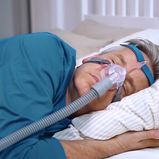 Person using a Löwenstein JOYCEone Nasal CPAP Mask while sleeping in bed