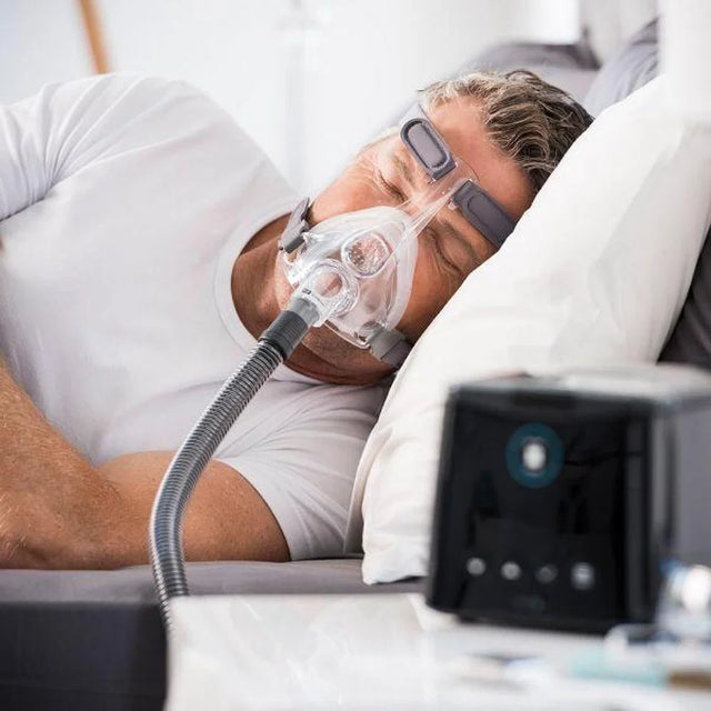 Man sleeping with Fisher & Paykel Simplus Full Face CPAP Mask on his face