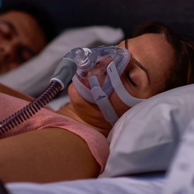 Woman wearing a ResMed AirFit™ F20 For Her - Full-Face CPAP Mask while sleeping