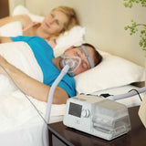 Man sleeping next to his wife while wearing BMC G3 B25A BPAP with Humidifier