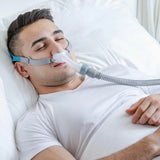 Man wearing a BMC P2 Nasal Pillow CPAP Mask while sleeping in bed