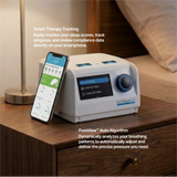 DeVilbiss Blue Auto Plus CPAP Machine on a nightstand with the compatible app displayed on a phone