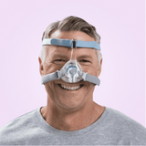 Man wearing a Fisher & Paykel Eson 2 Nasal CPAP Mask on a pink background