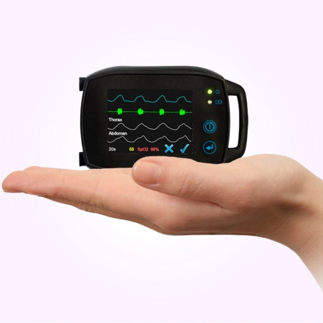 Hand holding SOMNOtouch™ RESP - wrist-worn polygraph showing it's incredible miniature size