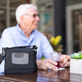 Man using O2P portable oxygen concentrator while having coffee outside