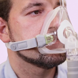 Close up view of a man, wearing a Löwenstein JOYCEone Full Face CPAP Mask