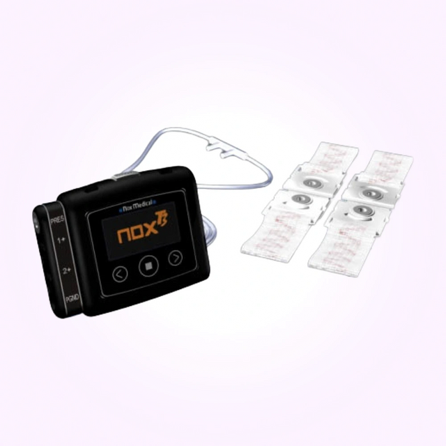 Side angle view of Nox T3 Portable Sleep Monitor for Home Sleep Testing next to belts
