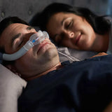 Man sleeping with ResMed AirTouch N30i Nasal CPAP Mask next to a sleeping woman