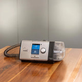 ResMed Lumis 100 VPAP ST Ventilator on a nightstand