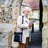 Woman carrying GCE Zen-O Lite portable oxygen concentrator in a bag on a walk