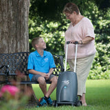 Woman carrying SeQual Eclipse 5 portable oxygen concentrator on a walk