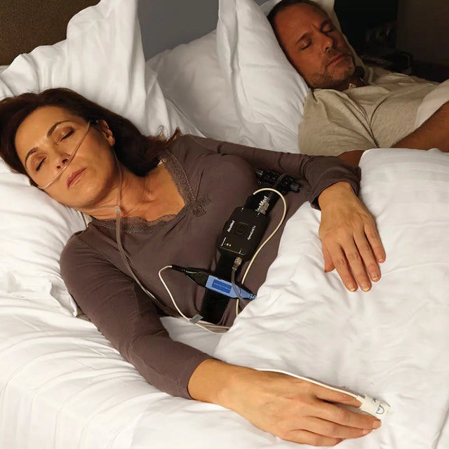 Woman sleeping with ResMed ApneaLink Air Home Sleep Testing Device