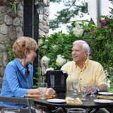 Woman using Inogen One G3 Portable Oxygen Concentrator while having dinner with partner