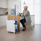 Woman using a Krober 4.0 Oxygen Concentrator in a kitchen.