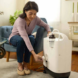 Woman using her Philips Oxygenate 5 Home Oxygen Concentrator